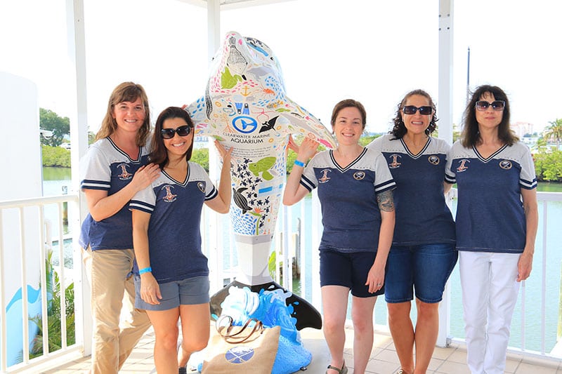 Backbone group photo with dolphin trail statue at Clearwater Marine Aquarium
