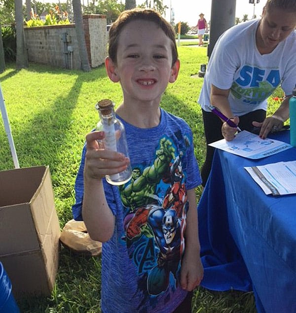 kid with message in a bottle